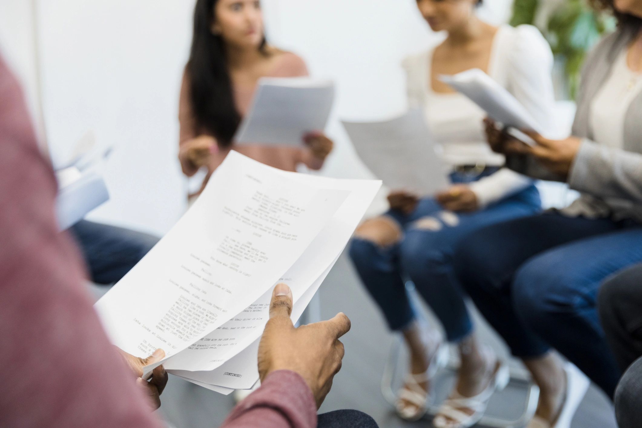 People discussing a script during a workshop