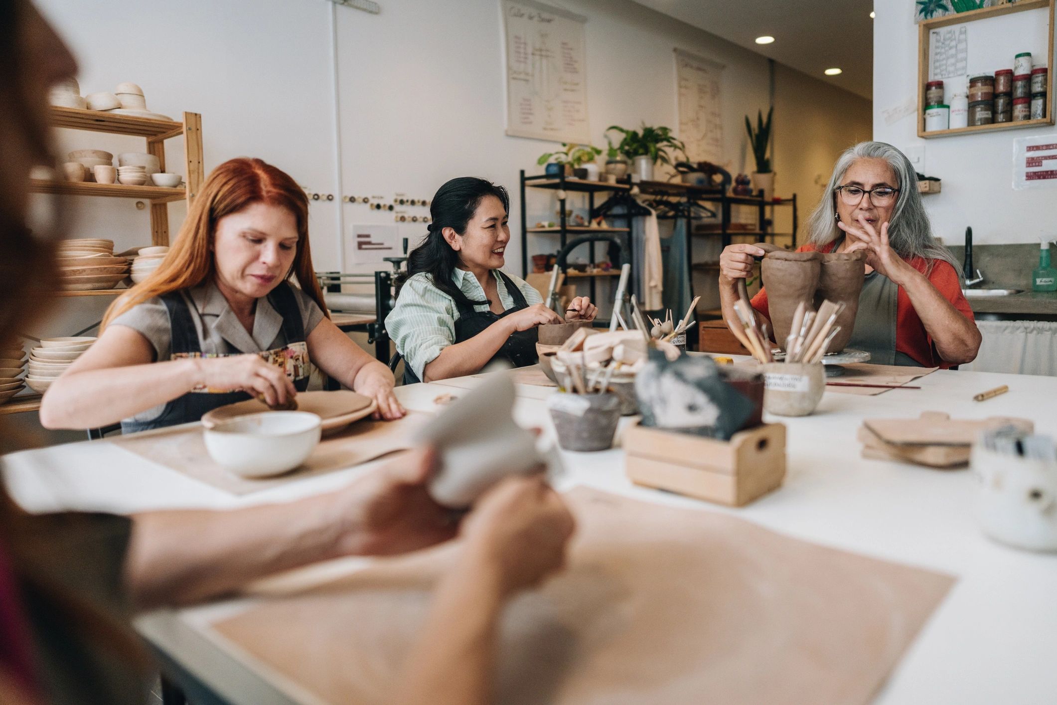 Participants shaping clay in a pottery workshop