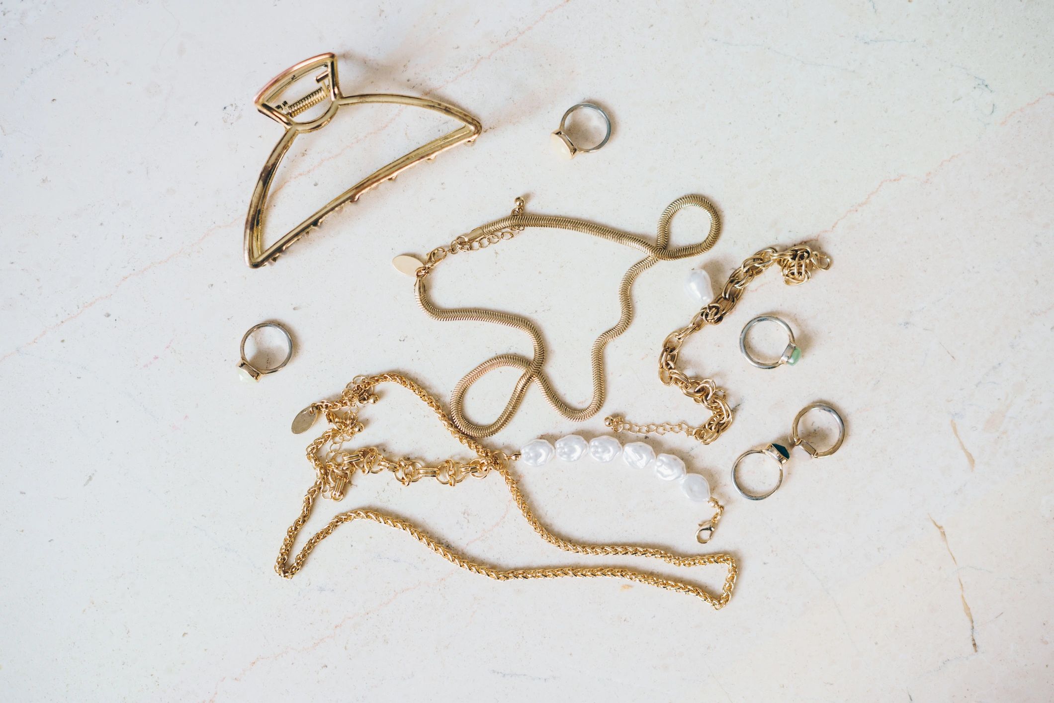 Handmade jewelry arranged on a marble surface